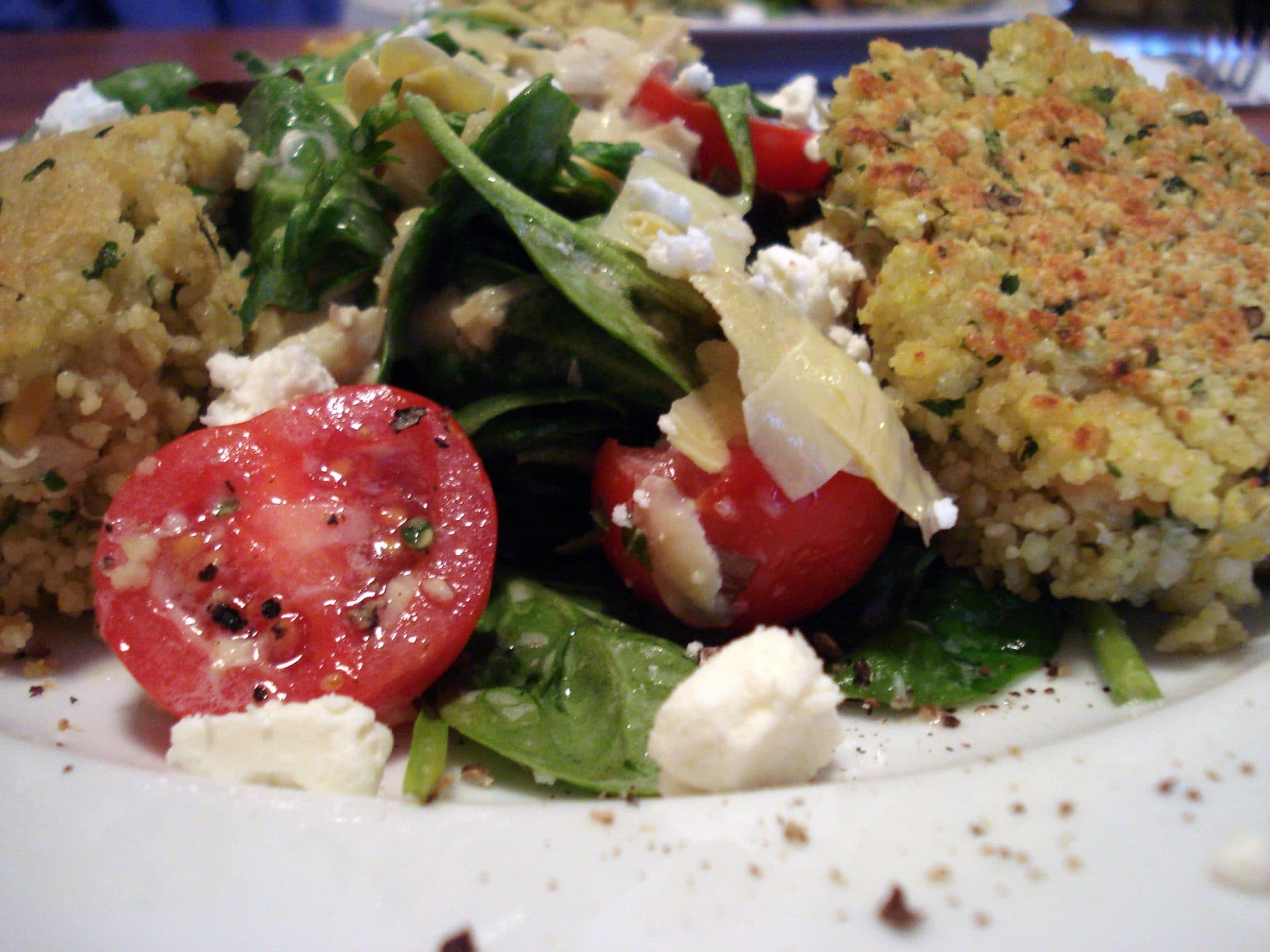 Close up of couscous cakes with salad