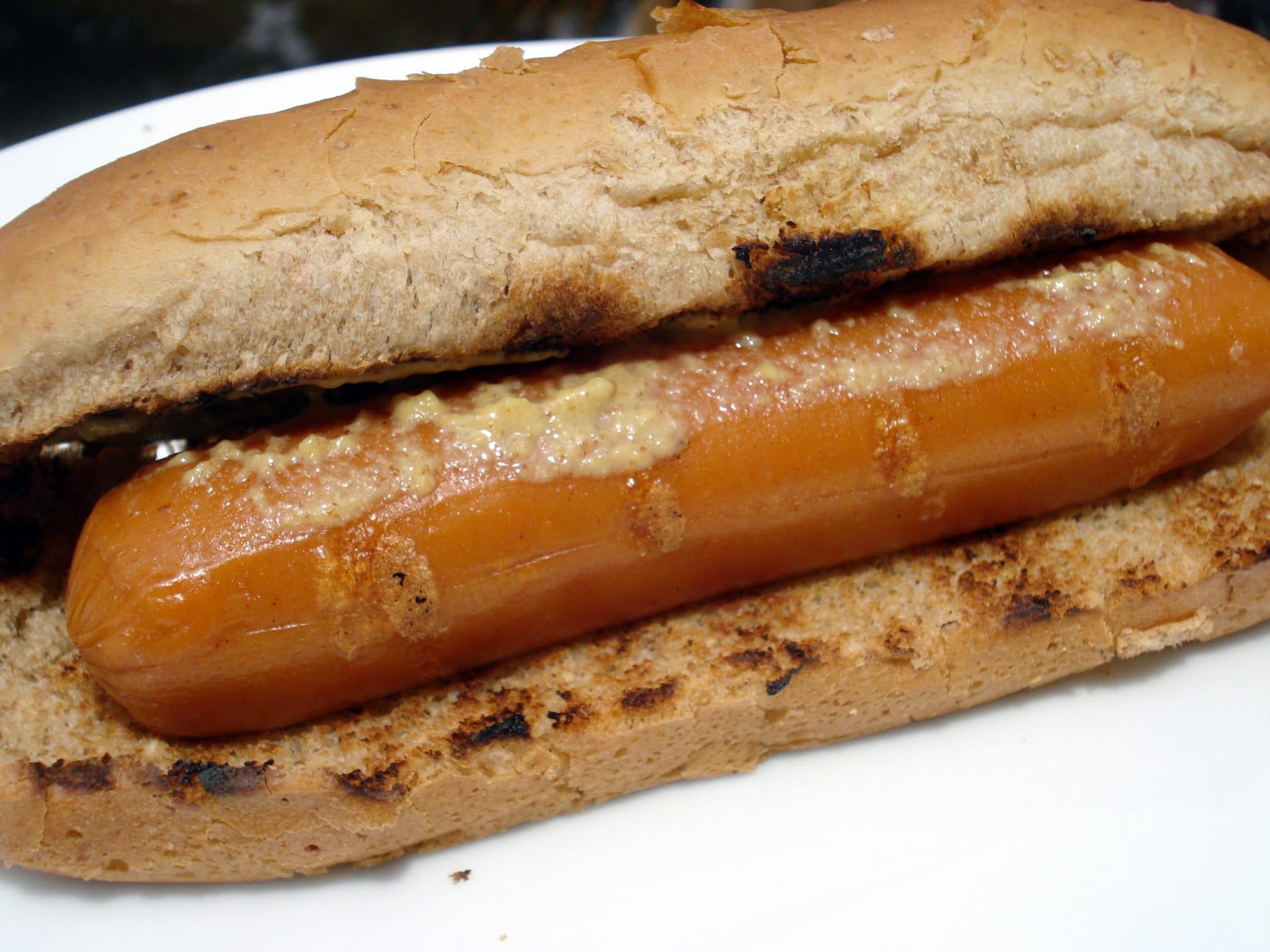 Vegan hotdog in a grilled, whole-wheat bun