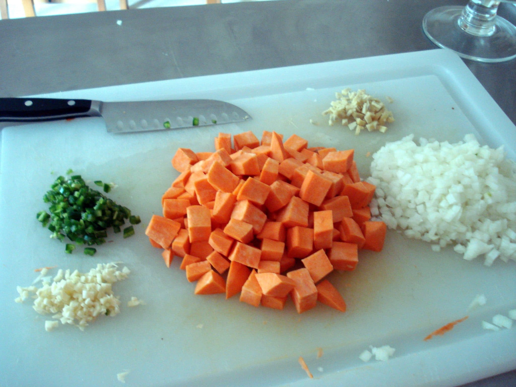 Chopped Ingredients to prepare Sweet Potato and Chickpea Curry with Green Peas