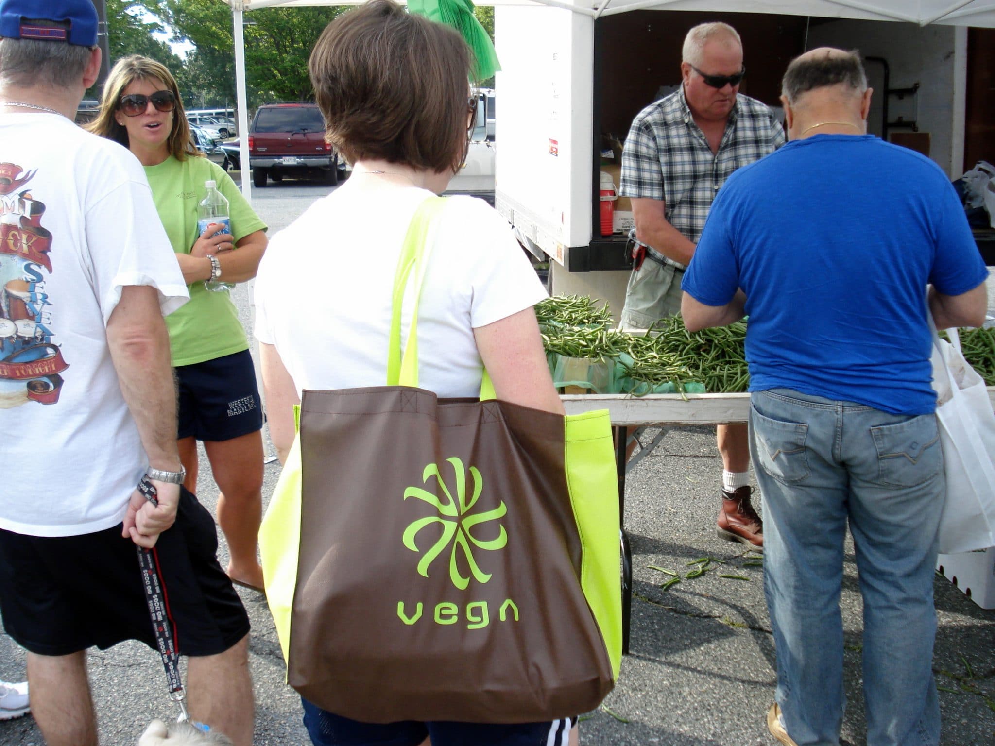 Woman carrying Vega Tote in line at farmers market