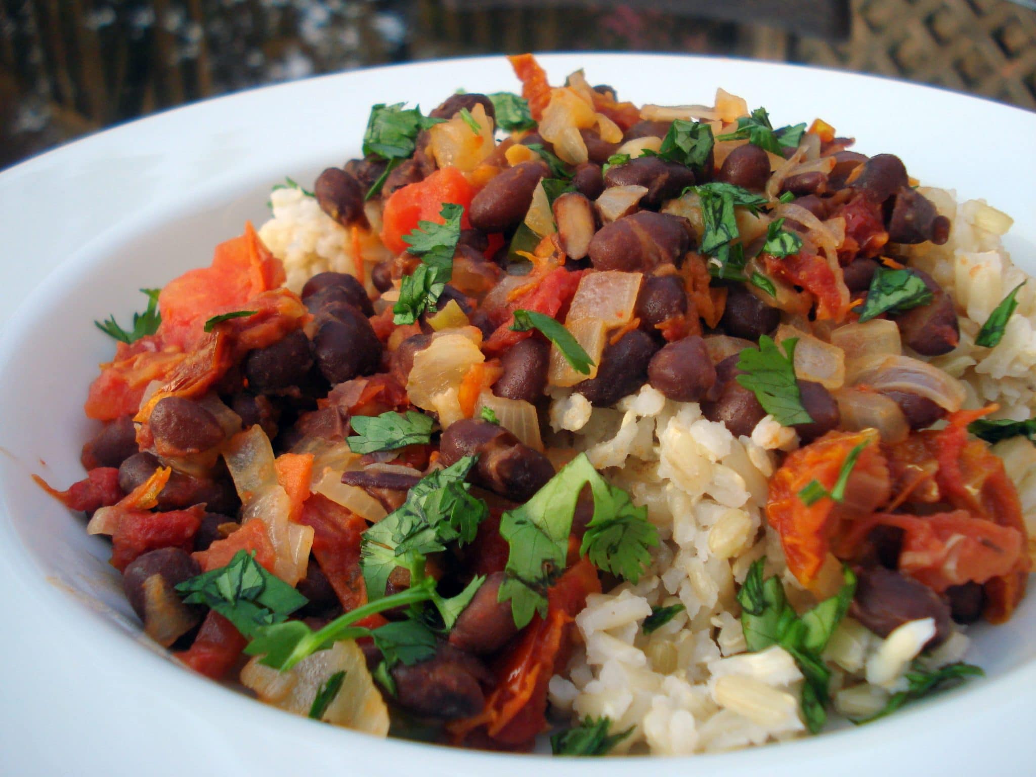 Rice with black beans, cilantro, onions and spices over rice