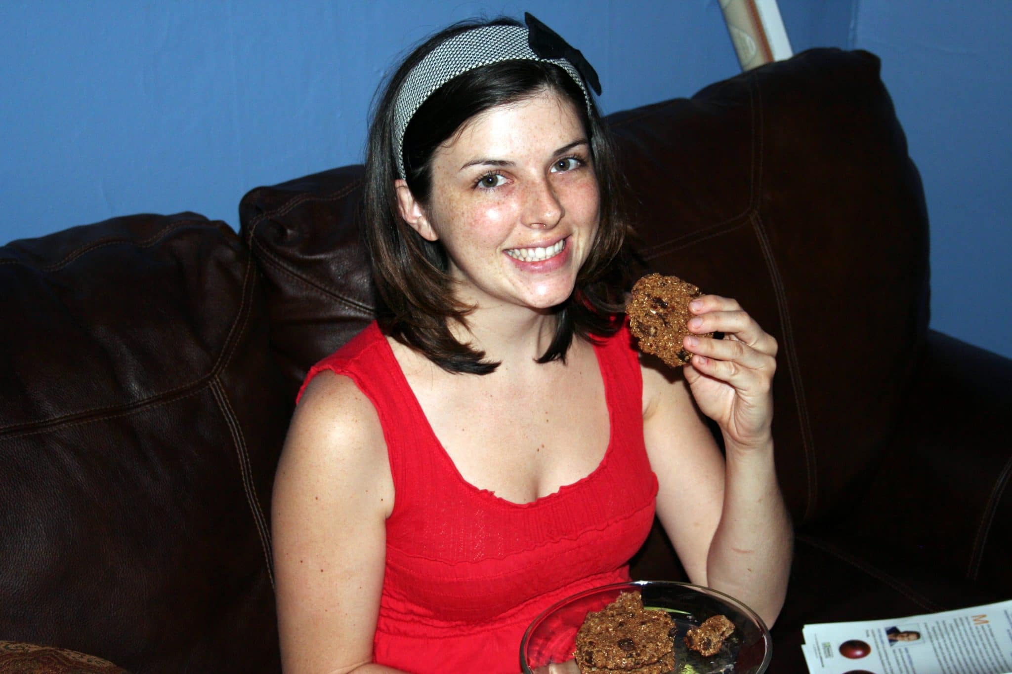 Woman eating vegan oatmeal raisin cookie