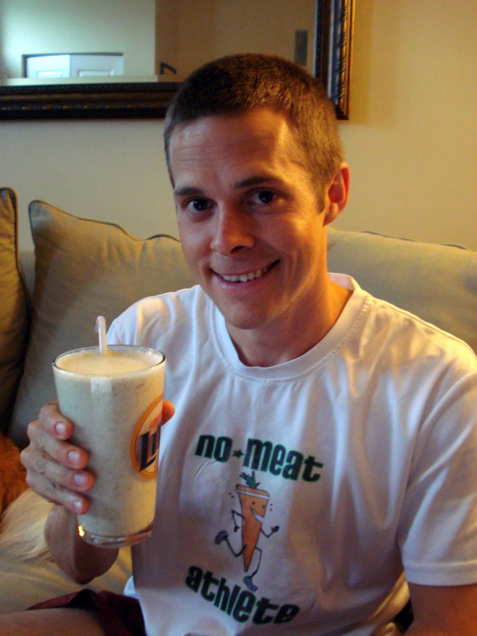 Matt, in NMA shirt, drinking Thrive Ginger Pear Smoothie