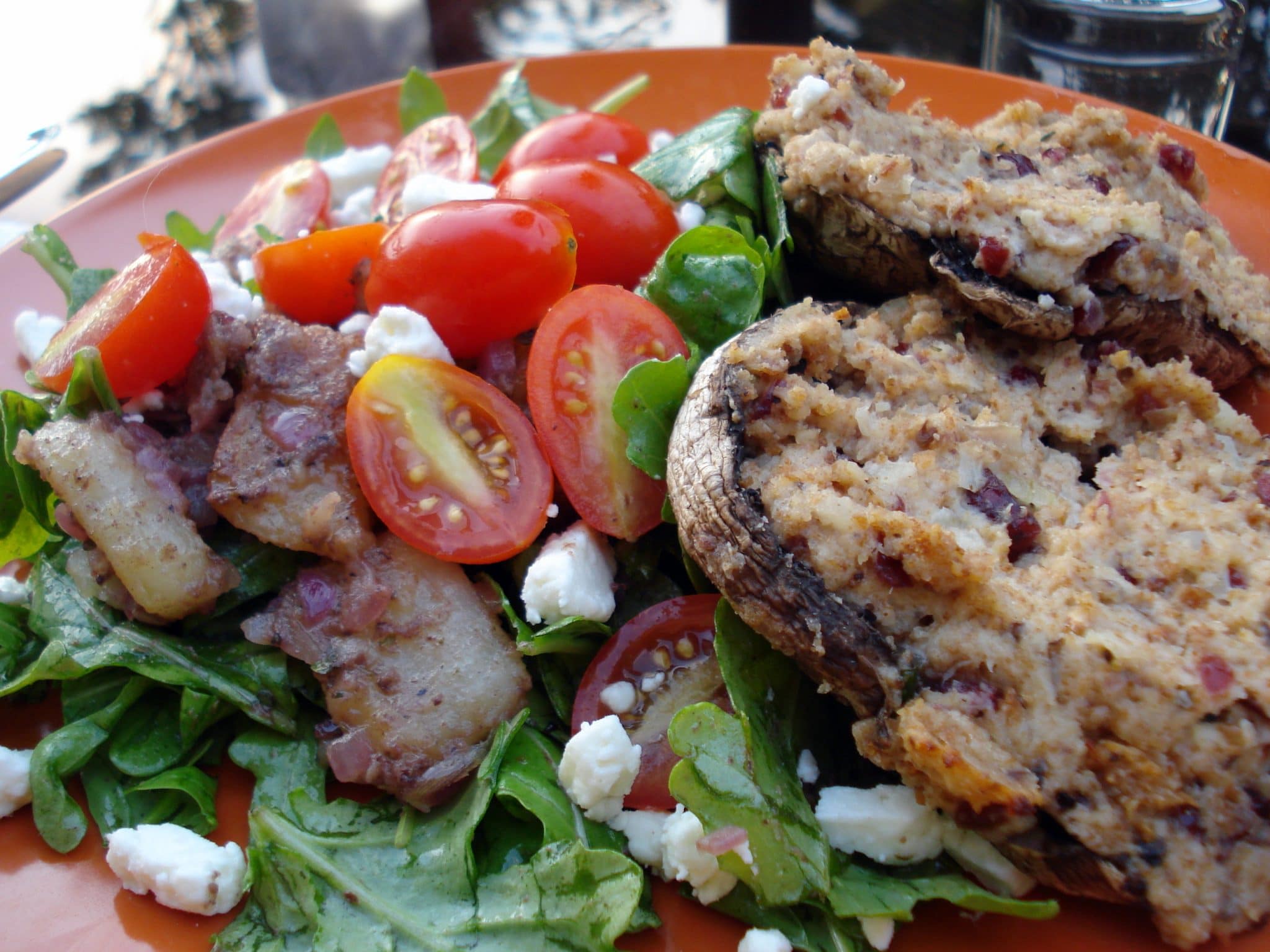 Close up of Goat Cheese and Rosemary Stuffed Portobello Mushrooms with side salad