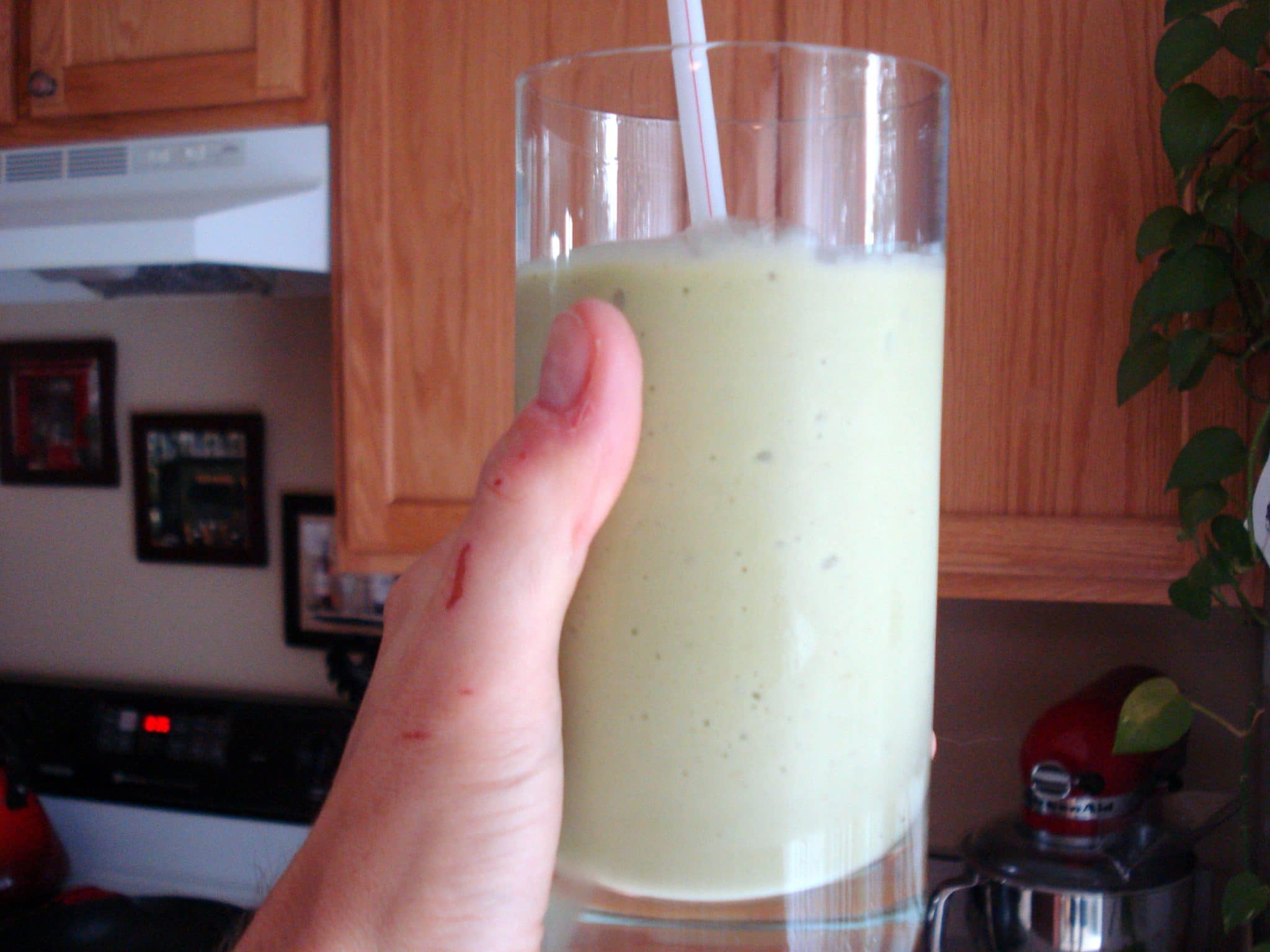 Glass of Avocado Banana Smoothie with straw