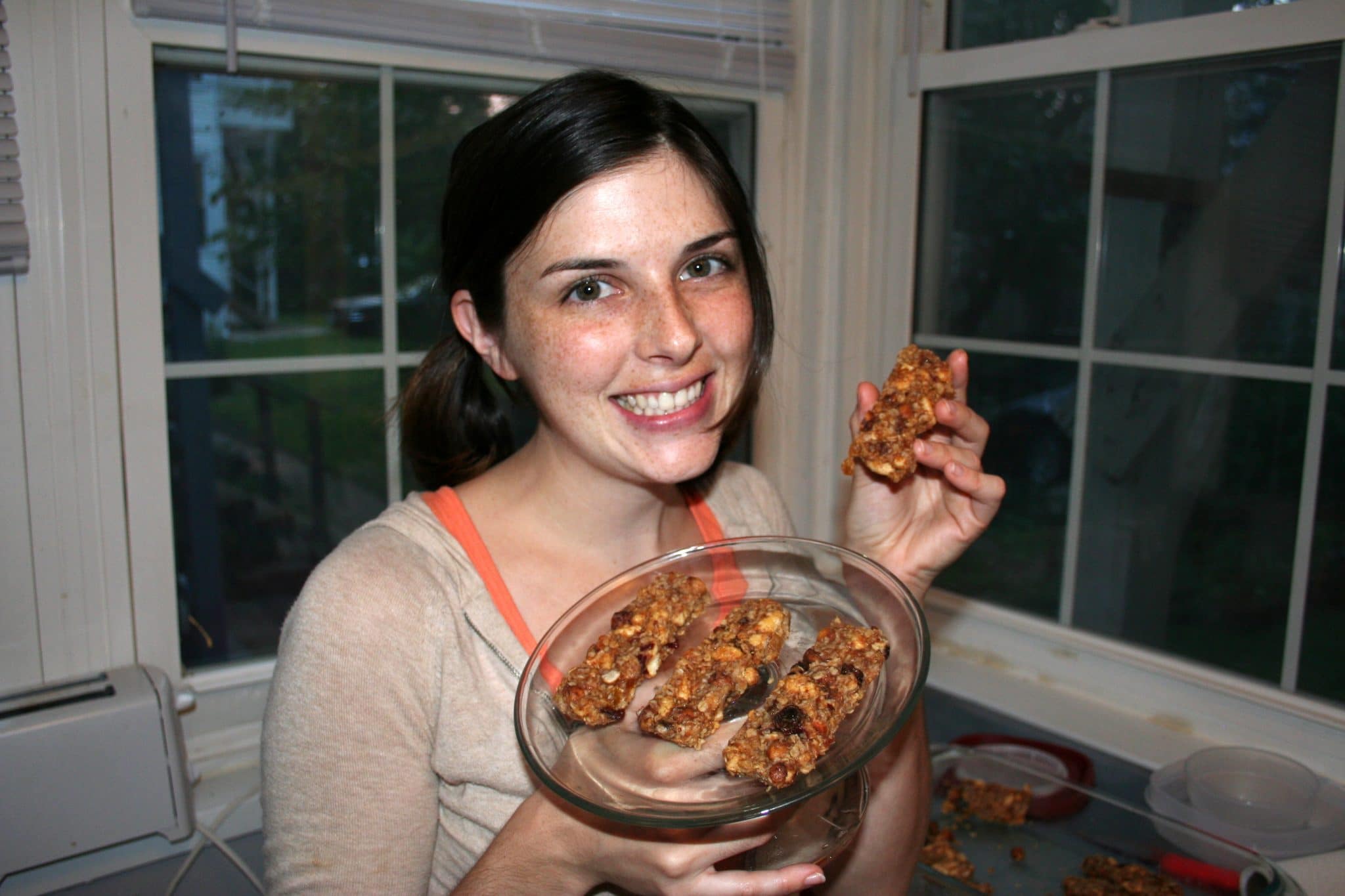 Woman holding plate of Chickpea Granola Bars