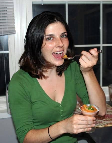 Woman eating steamed peaches with custard