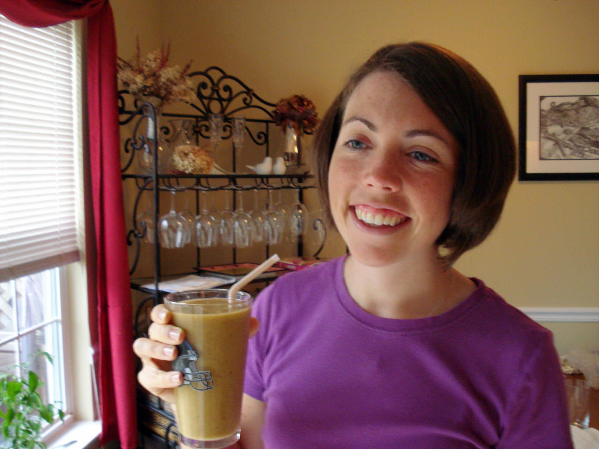 Erin Frazier drink pineapple smoothie in a glass