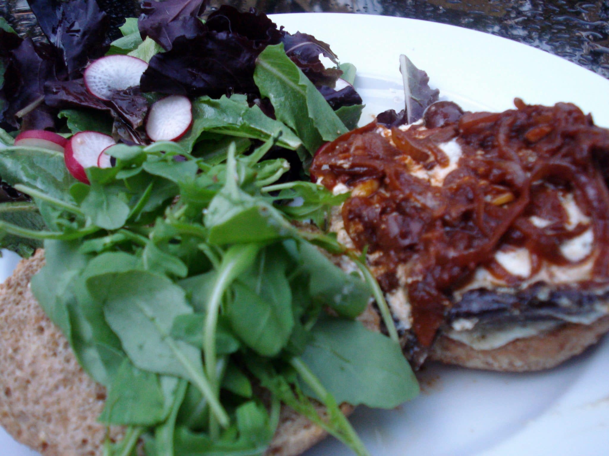 Open face sandwich of Pesto-Ricotta Portobello Burgers Recipe with baby spinach