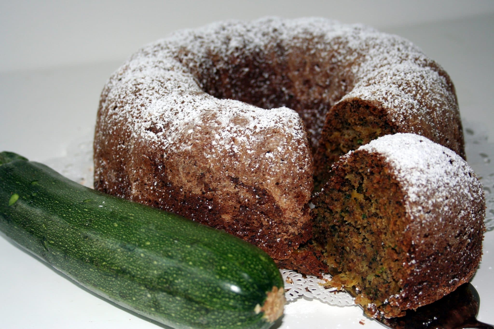 Lemon Poppy Zucchini Bread with a raw zucchini