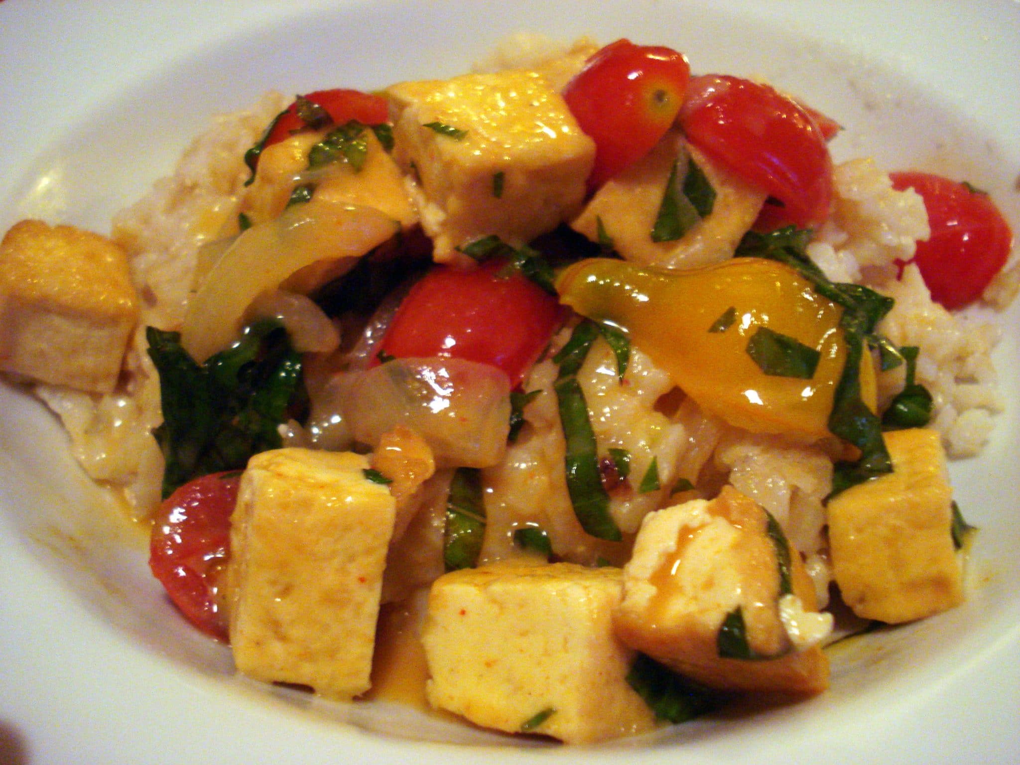 Plate of Tofu Curry with onions and tomatoes