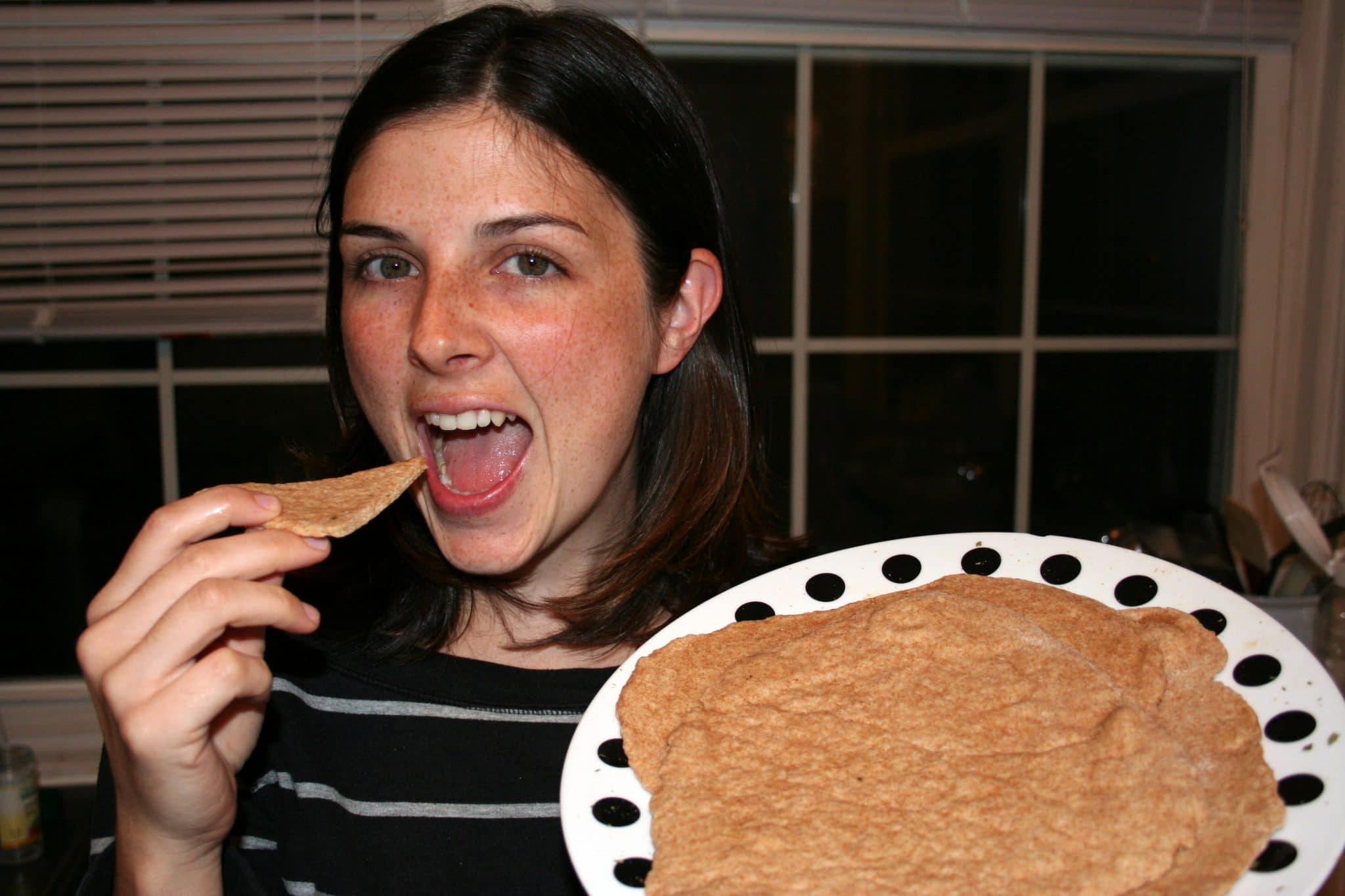 Woman eating vegan flatbread