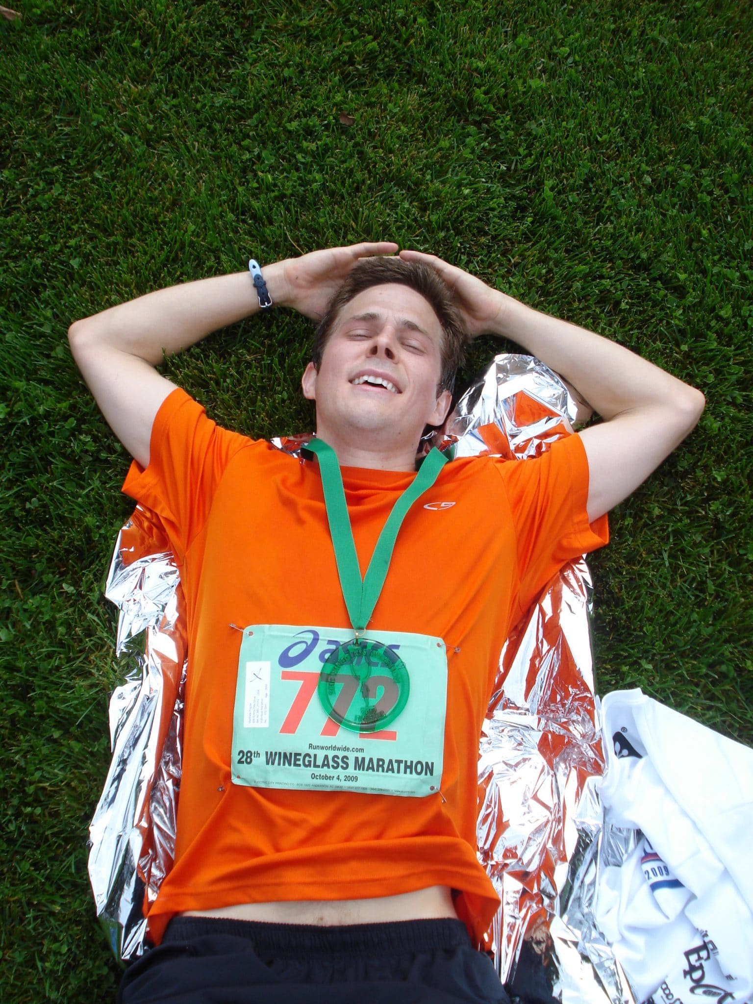 Matt laying in grass after completing Wineglass Marathon and qualifying for Boston