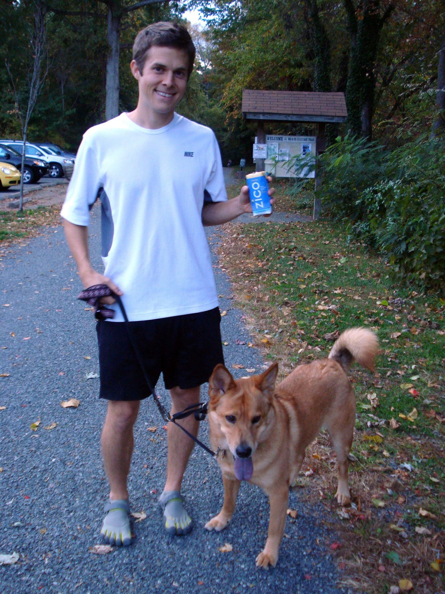 Matt walking dog carrying Zico coconut water