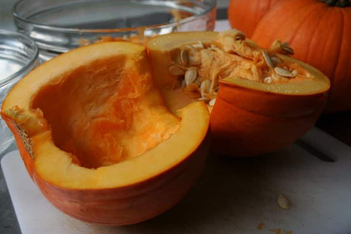 Pumpkin cut in half with seeds exposed