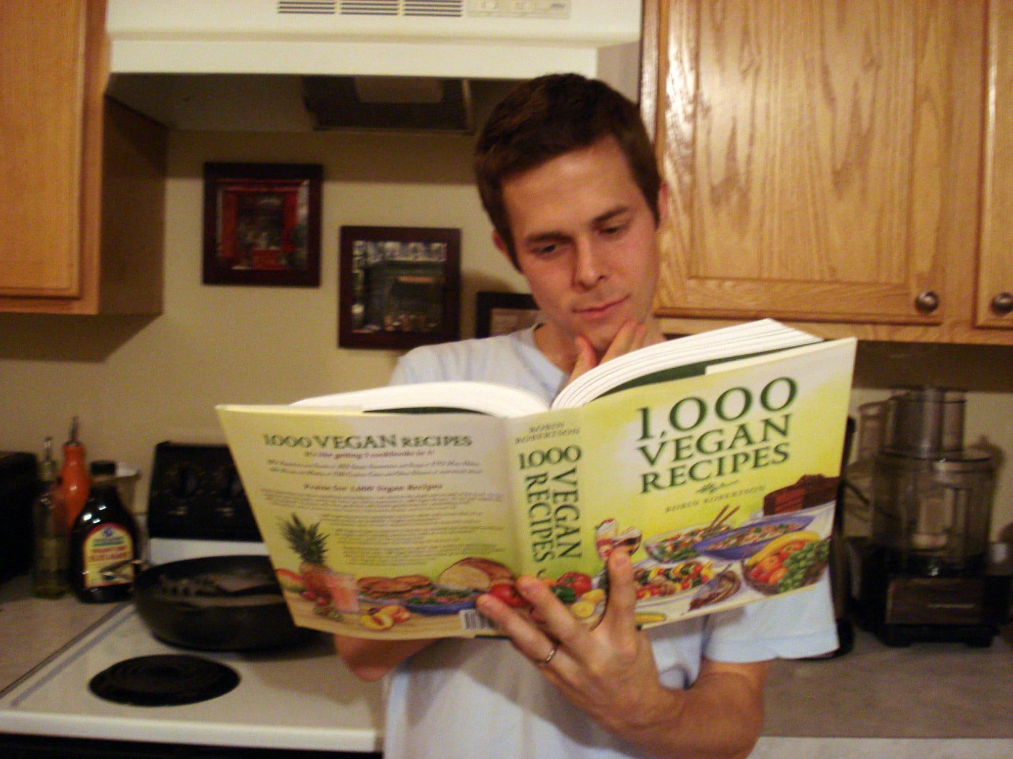 Matt reading 1,000 Vegan Recipes Cookbook