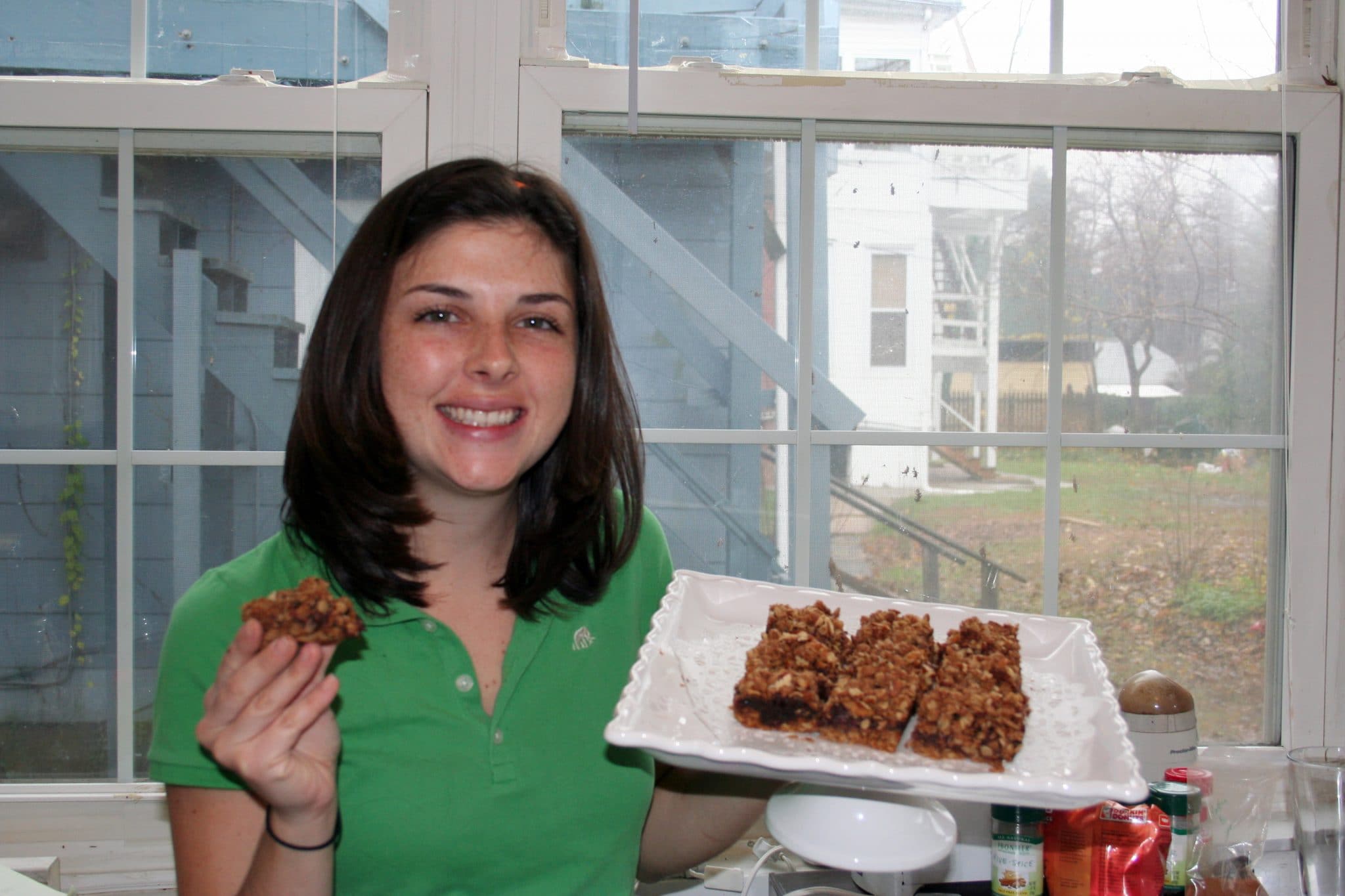 Woman holding plate of Vegan Cranberry Spinach Bars