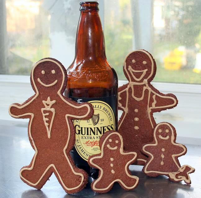 Bottle of Guinness with gingerbread family around it