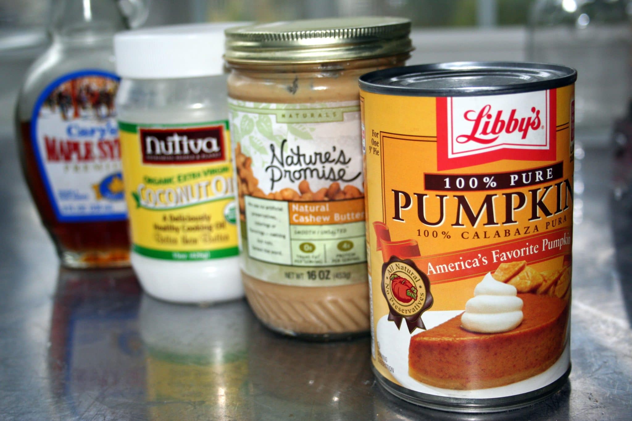 ingredients to make Vegan Pumpkin Pie - can of pumpkin, cashew butter, coconut oil, and maple syrup