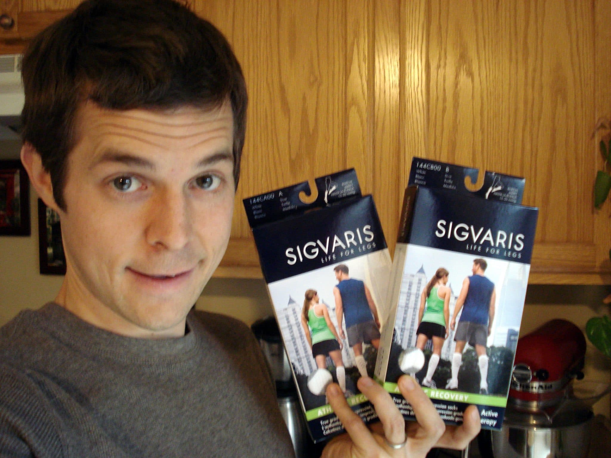 Matt holding 2 boxes of SIGVARIS compression socks