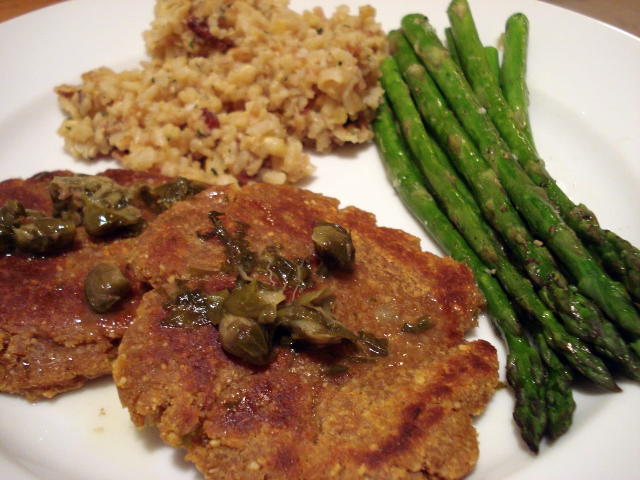 Piccata-style cashew chickpea medallions with a side of asparagus and rice