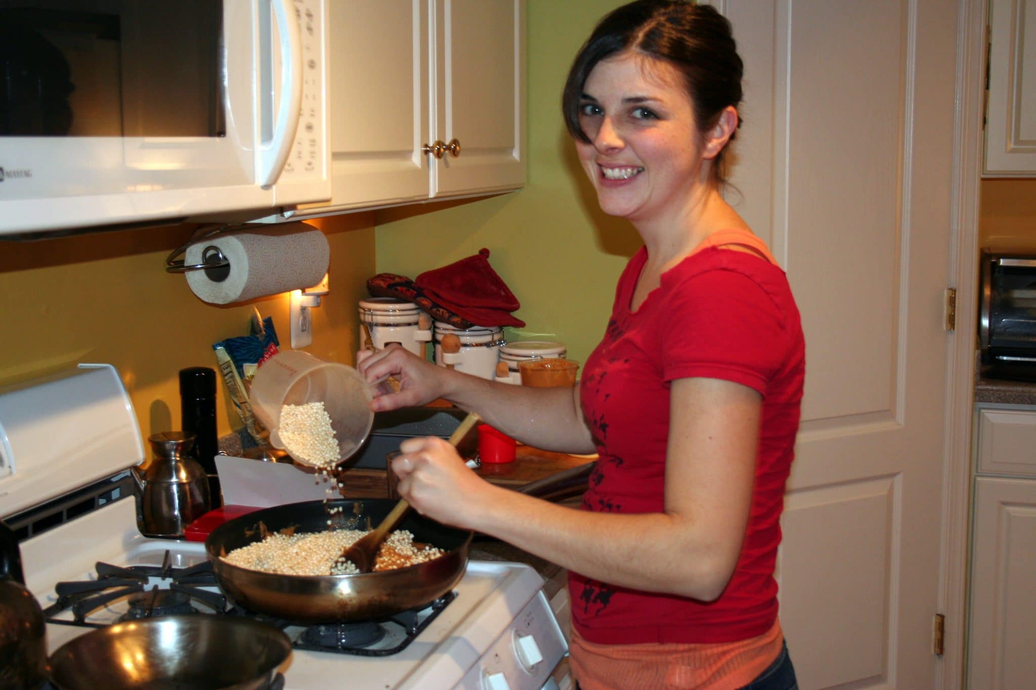 Woman cooking millet treats on stove top