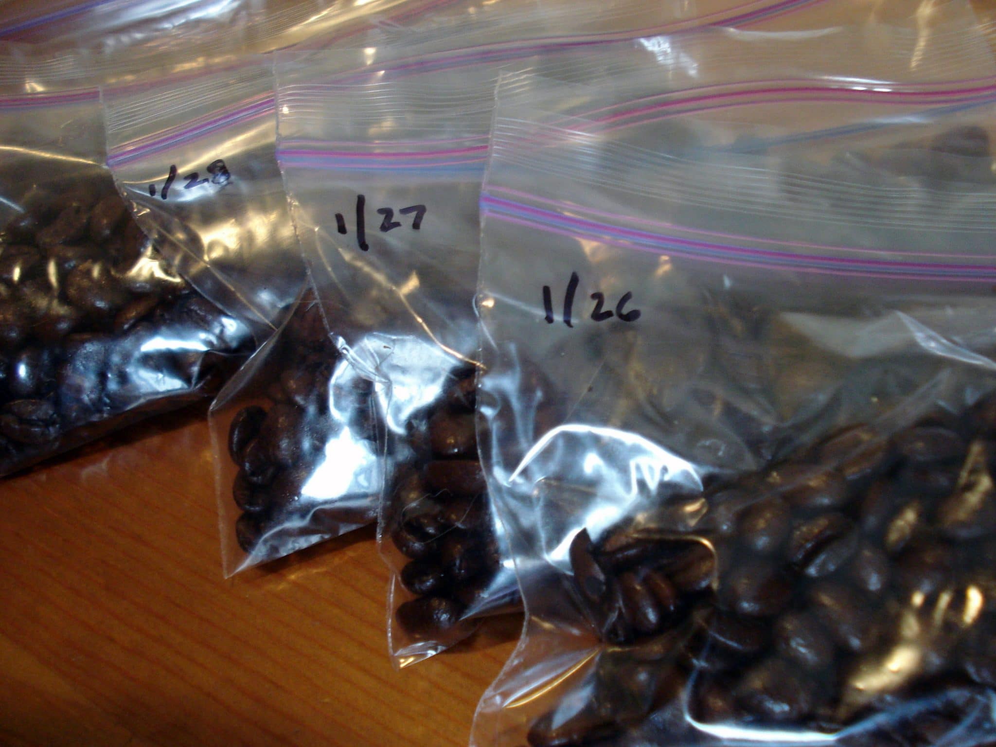 Zip lock bags with dates of pre portioned whole bean coffee