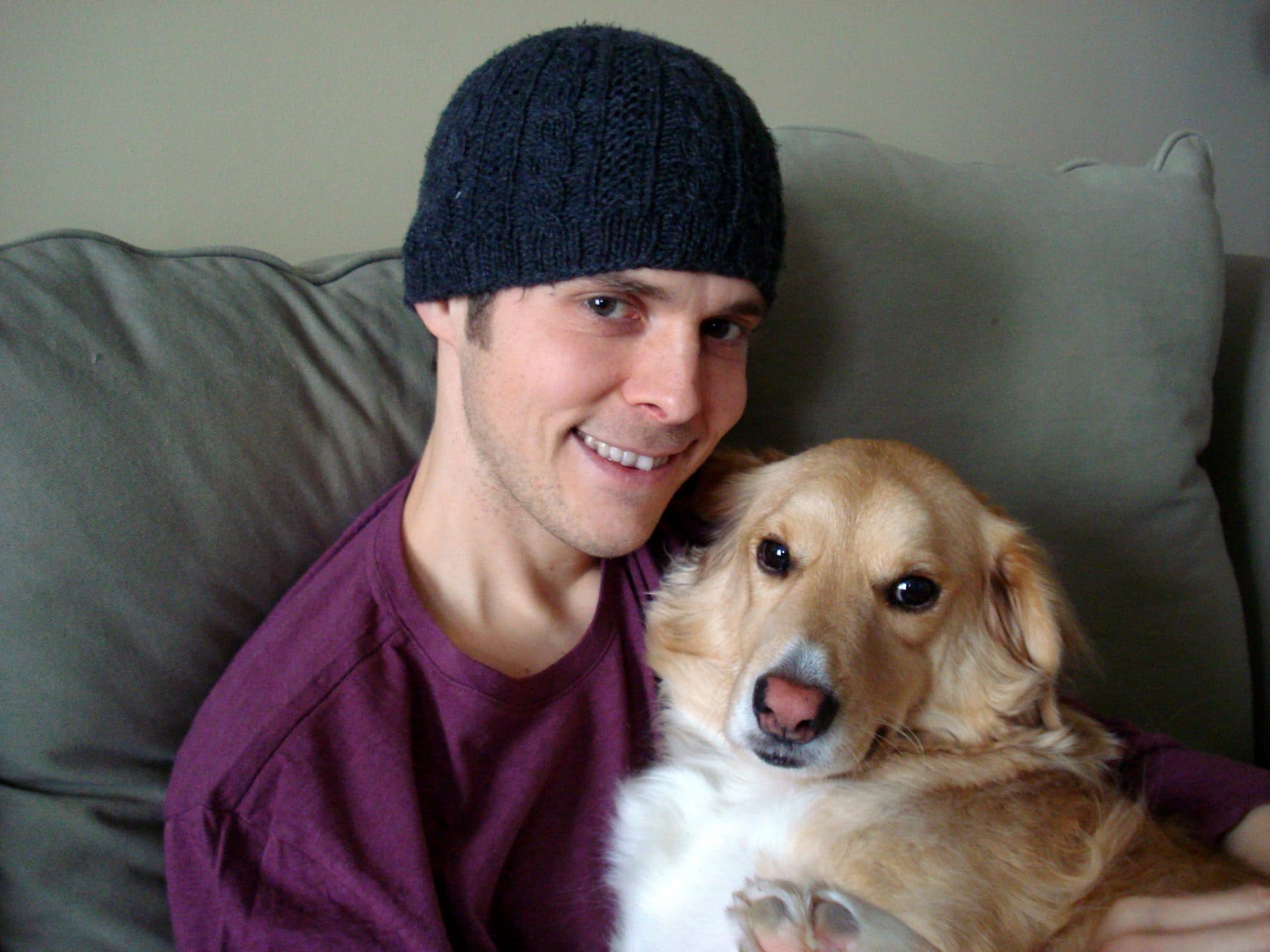 Matt sitting on couch with golden retriver