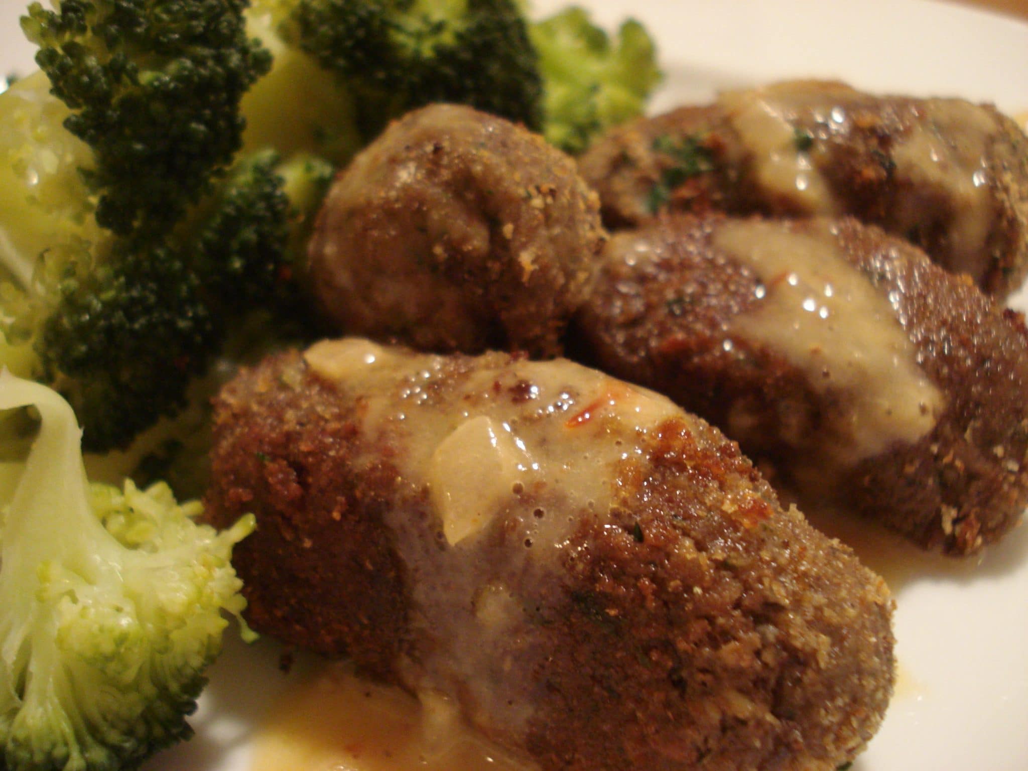 Close up of Black bean and walnut croquettes with a side of broccoli