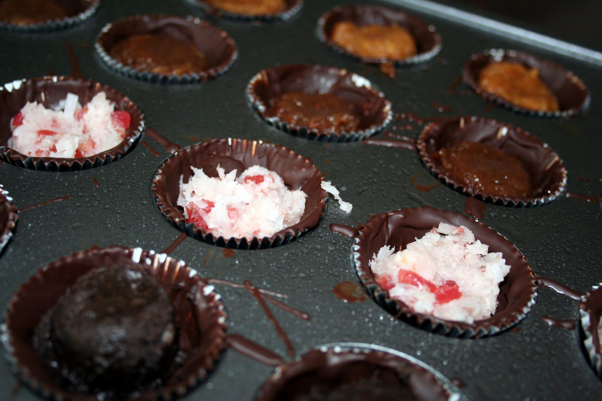 Close up of vegan chocolates in muffin tin preparing to go into the oven