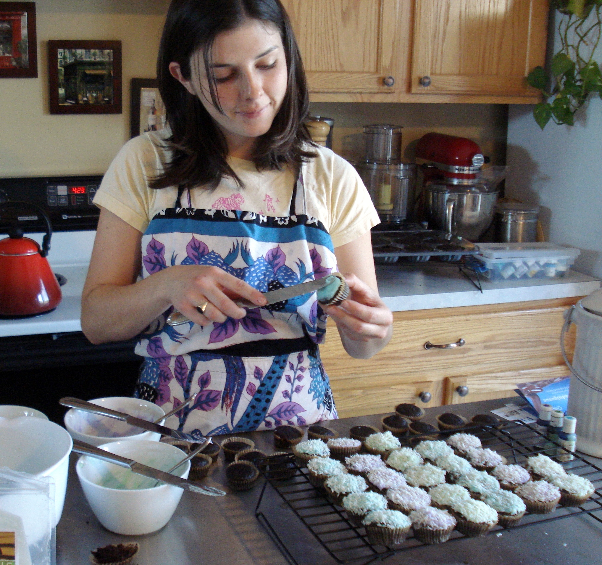 Christine adding ganache to cupcakes
