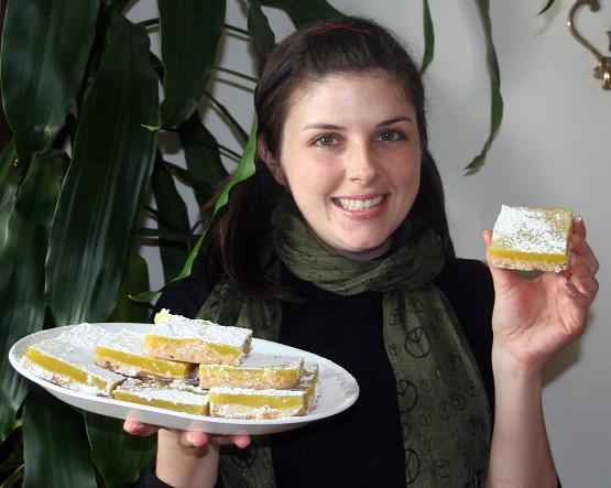 Christine holding plate of vegan lemon bars