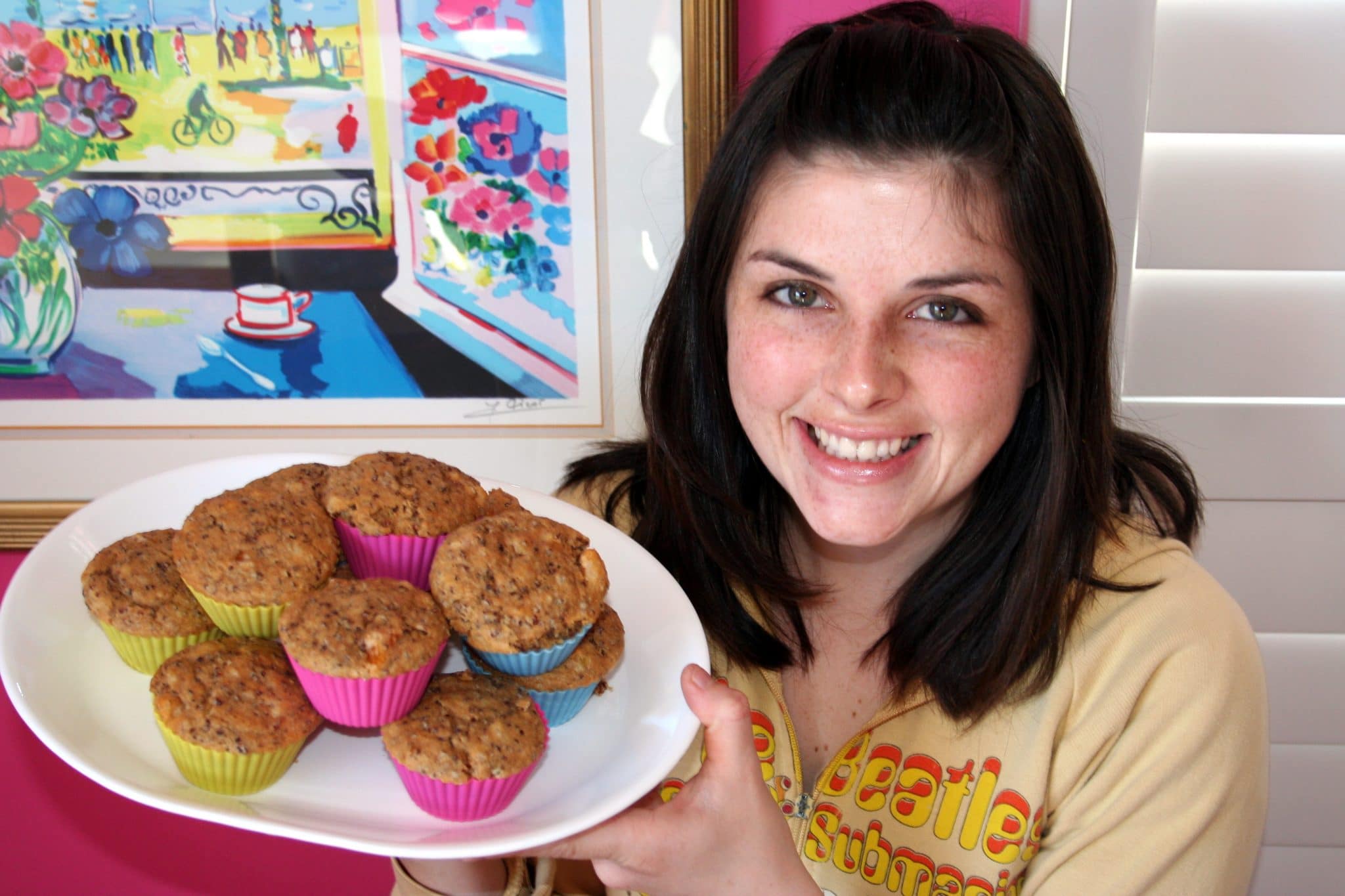 Christine holding plate of Vegan Almond-Quinoa Muffins