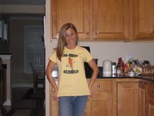 Woman in kitchen wearing yellow throwback carrot NMA shirt