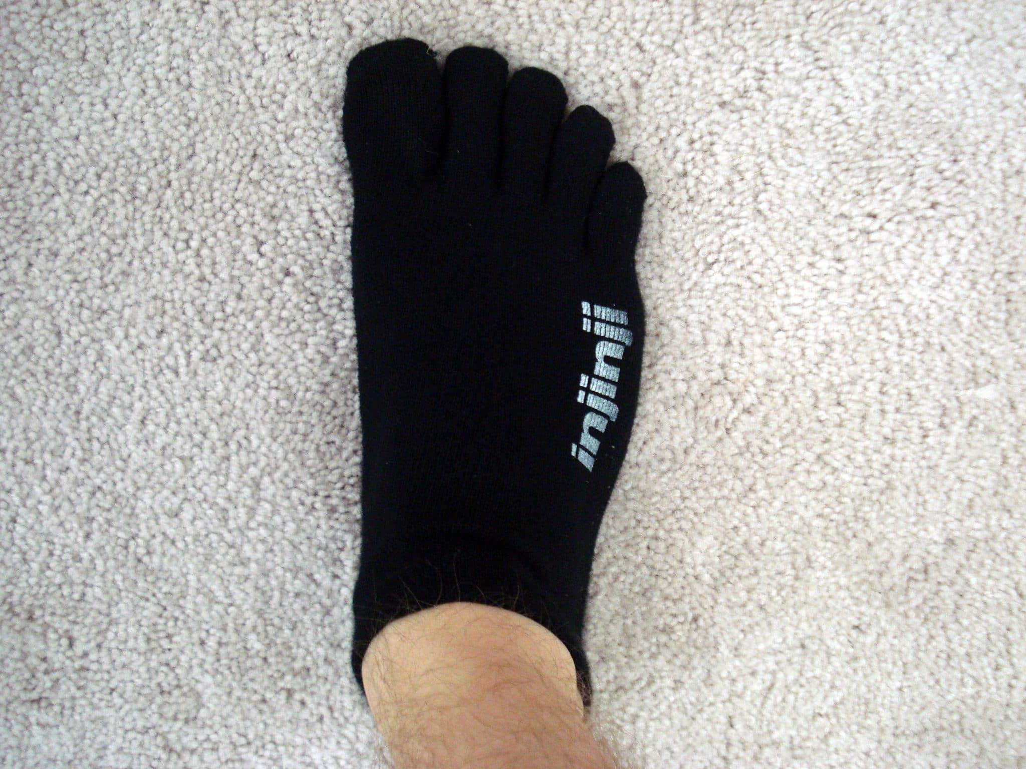 Right foot wearing black toe socks