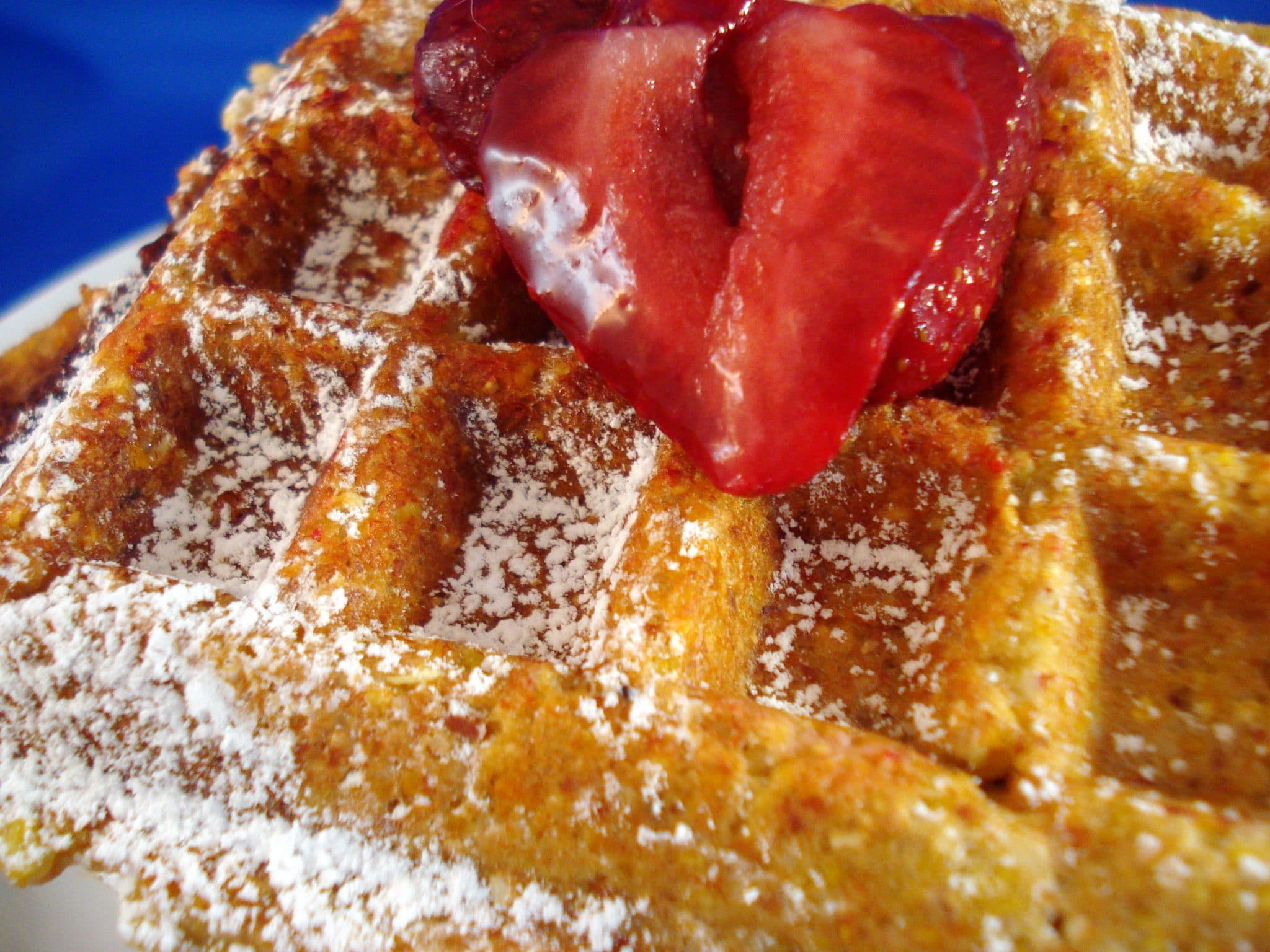 Tarahumara Chia waffles with powdered sugar and a strawberry