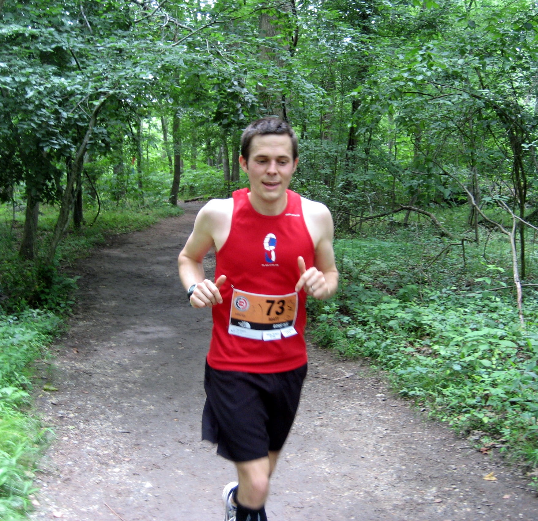 Matt running down path enclosed by trees