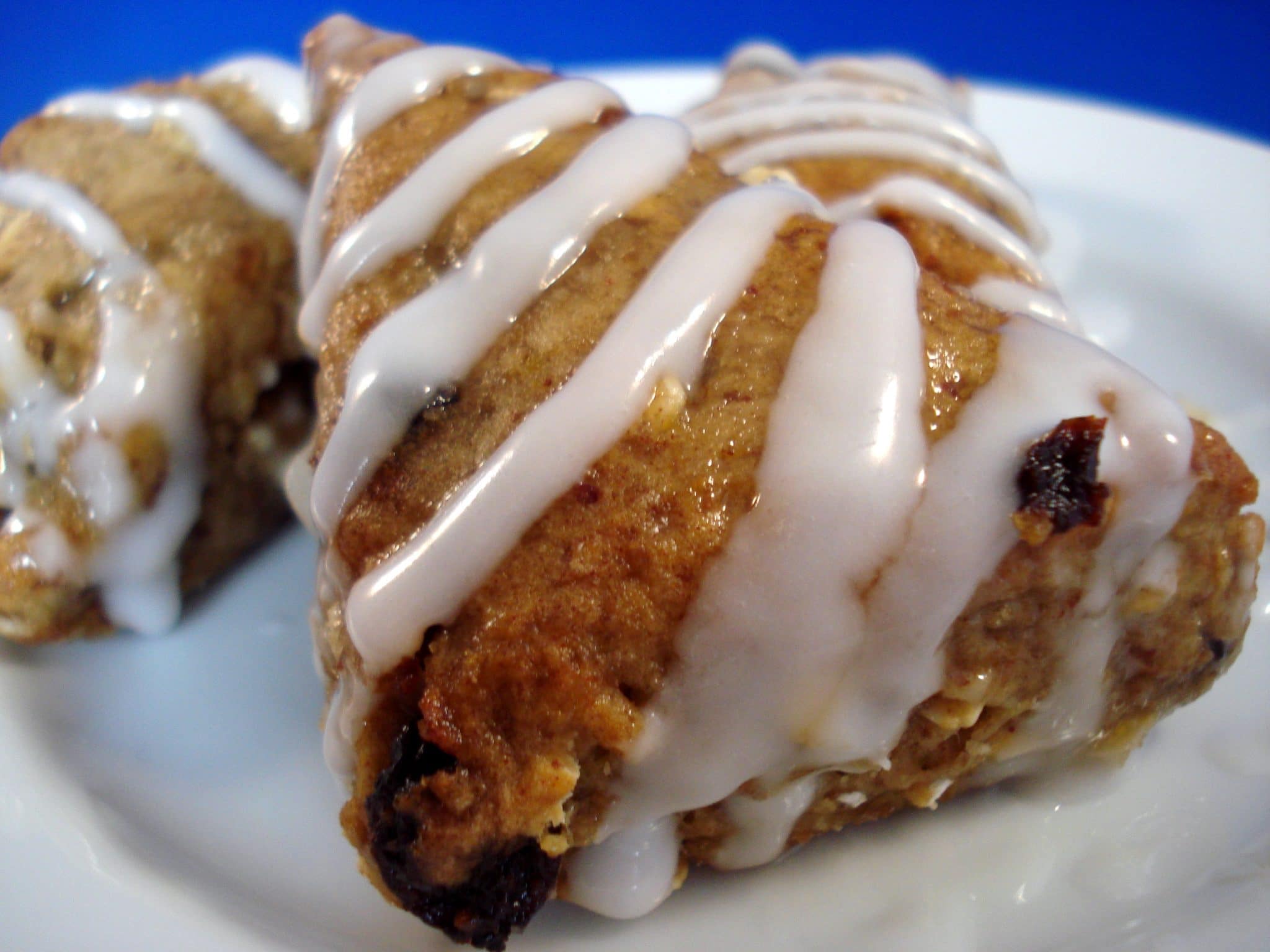 Close up of blueberry scone drizzled in white icing