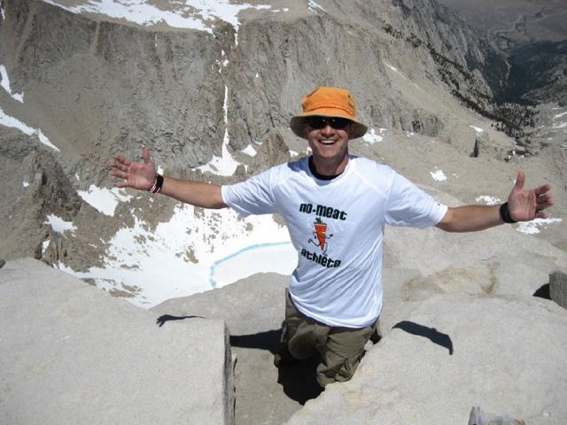 man in throwback carrot shirt on mountain