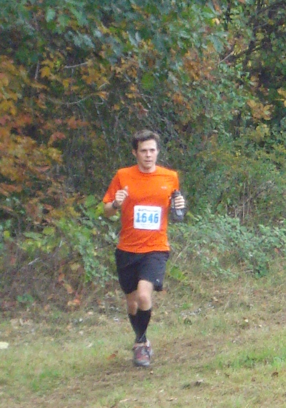 Matt running on grass with fall leaves behind him