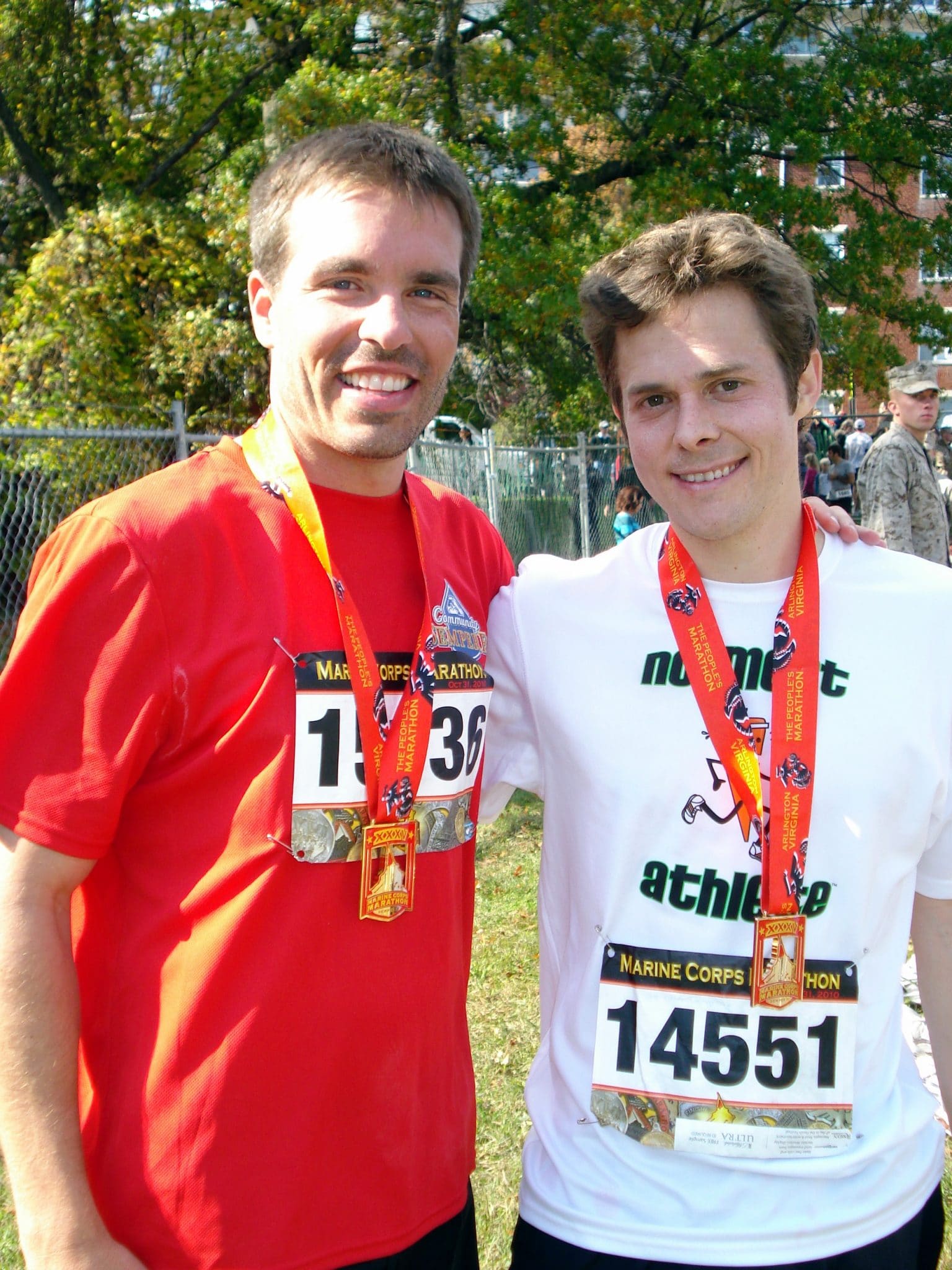 Matt and brother in law wearing finishers medal at Marine Corps Marathon 2010