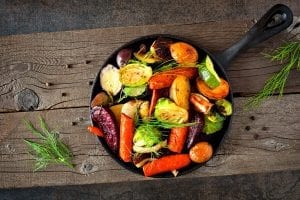 Cast iron skillet of colorful roasted vegetables