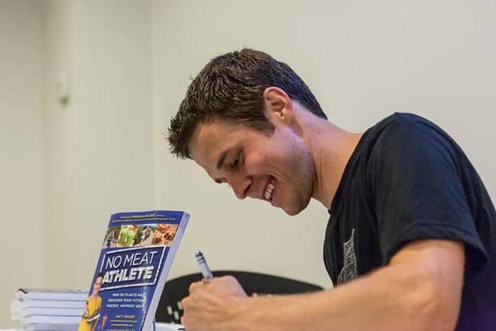 Matt Signing books in NYC after a run in Central Park. Photo courtesy Ben Ko.