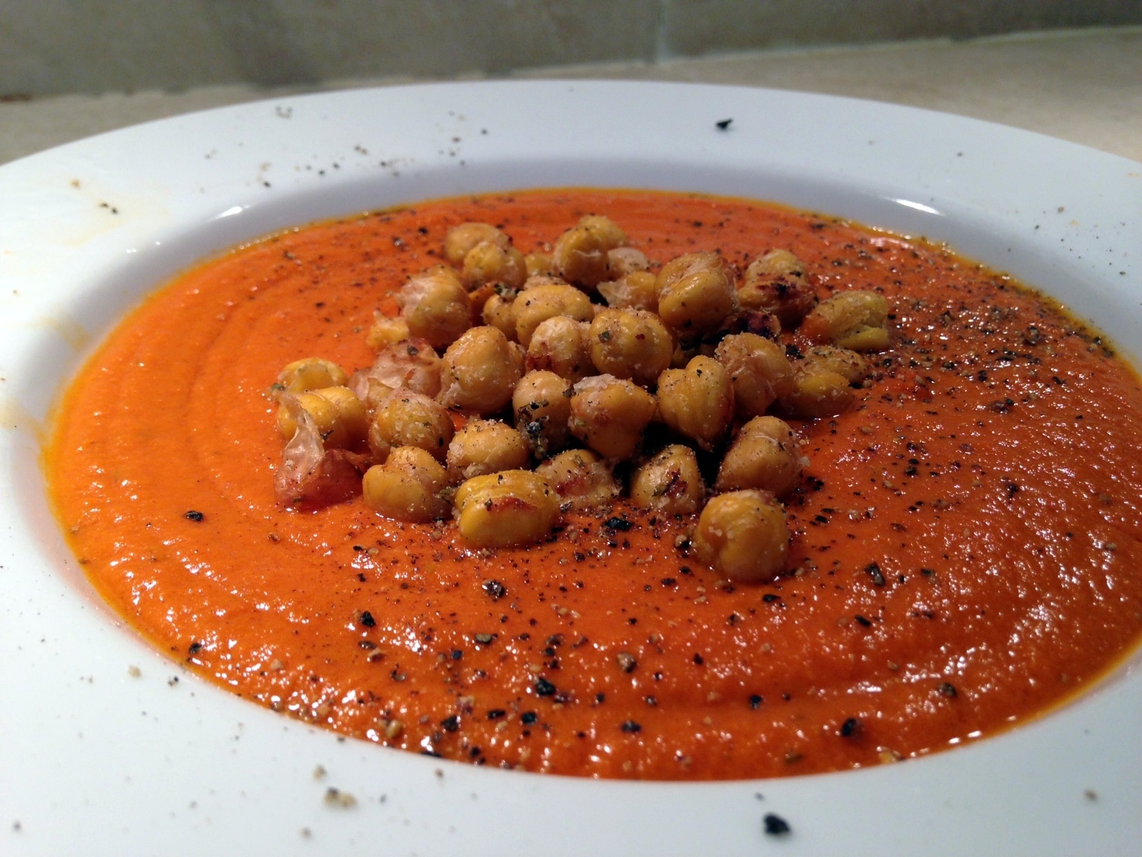 Large white bowl of Creamy Tomato Soup with Roasted Chickpeas
