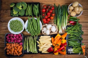 Fresh produce organized on a table for meal prep