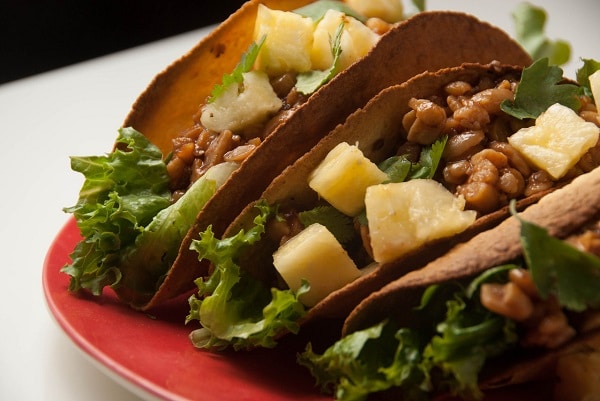 Red plate of 3 Hawaiian BBQ lentil tacos